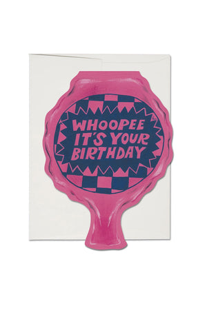 Birthday greeting card in the shape of a pink Whoopee Cushion. The card says Whoopee it's your birthday on it. White envelope.