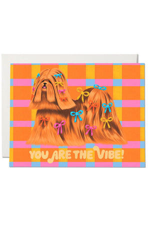 Greeting card of a long haired dog with bows in its hair. Card says you are the vibe.