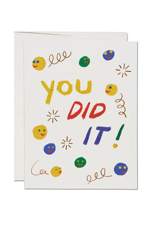 Greeting card of different smiley faces and squiggles. Card says You Did It!