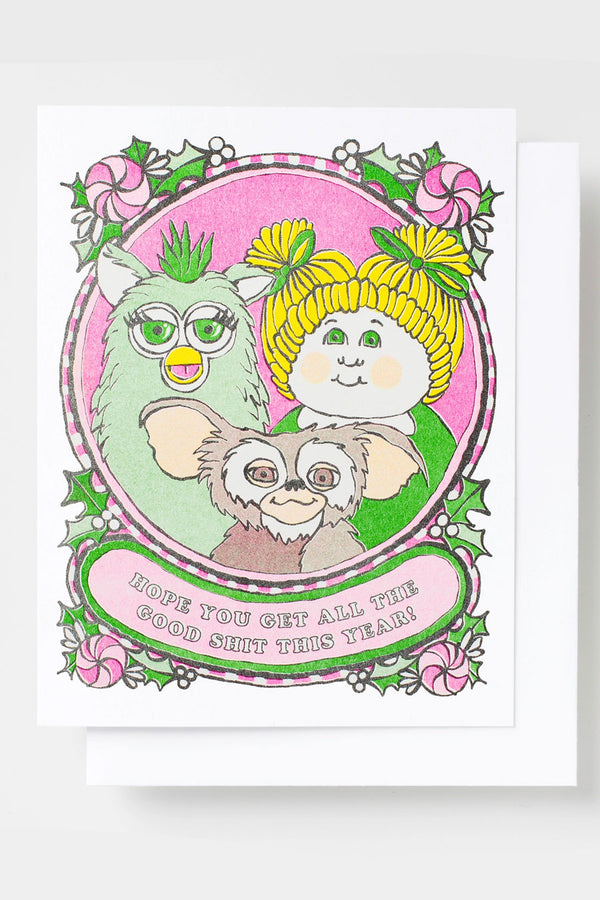 Greeting card featuring illusration of cabbage patch doll, mogwai, and a furby. surrounded candy and holly leaves.