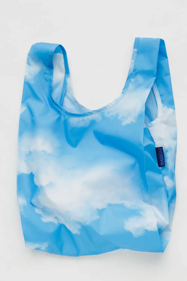 Small reusable shopping bag that features realistic cloud design against a blue sky. White background.
