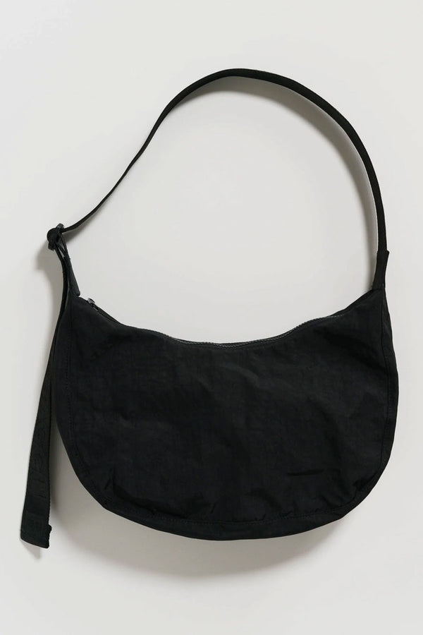 Nylon crescent shaped bag in black with black straps. White background.