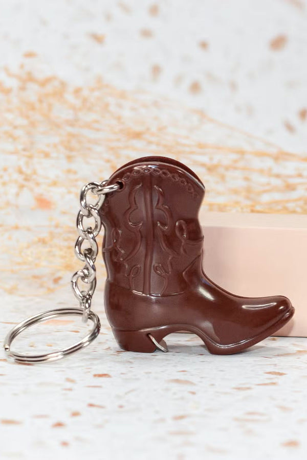 Plastic cowboy boot shaped bottle opener with silver keychain.