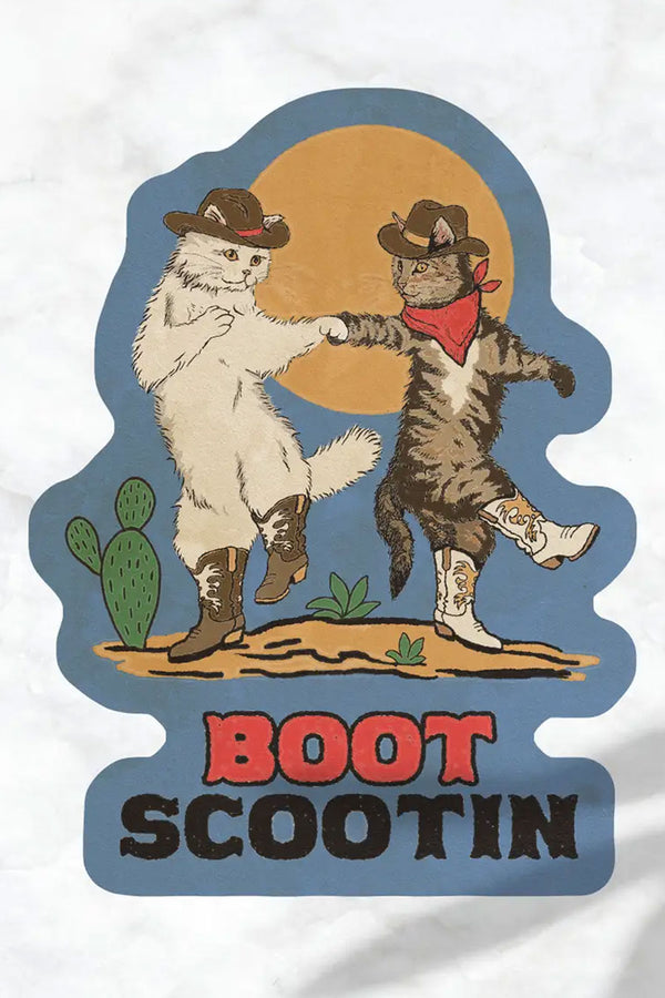 Blue die cut sticker featuring illustration of two cats wearing cowboy boots and hats, dancing in the desert. Below that the sticker says Boot scootin in wester font. White background.