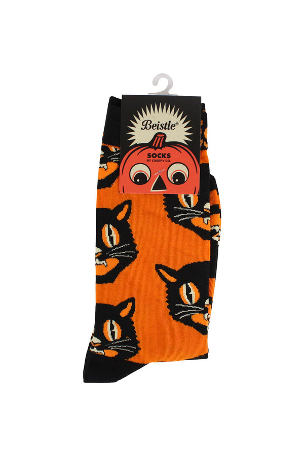 Orange pair of socks with black toe and heels. The socks features a repeating pattern of the Beistle black cat. White background.