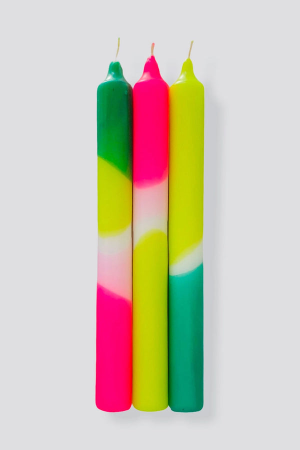 Set of three taper candles hand dyed in green, lime, and pink neon colors.