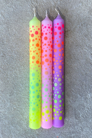 Set of three taper candles hand dipped in rainbow gradient colors and with hand printed dots all over.