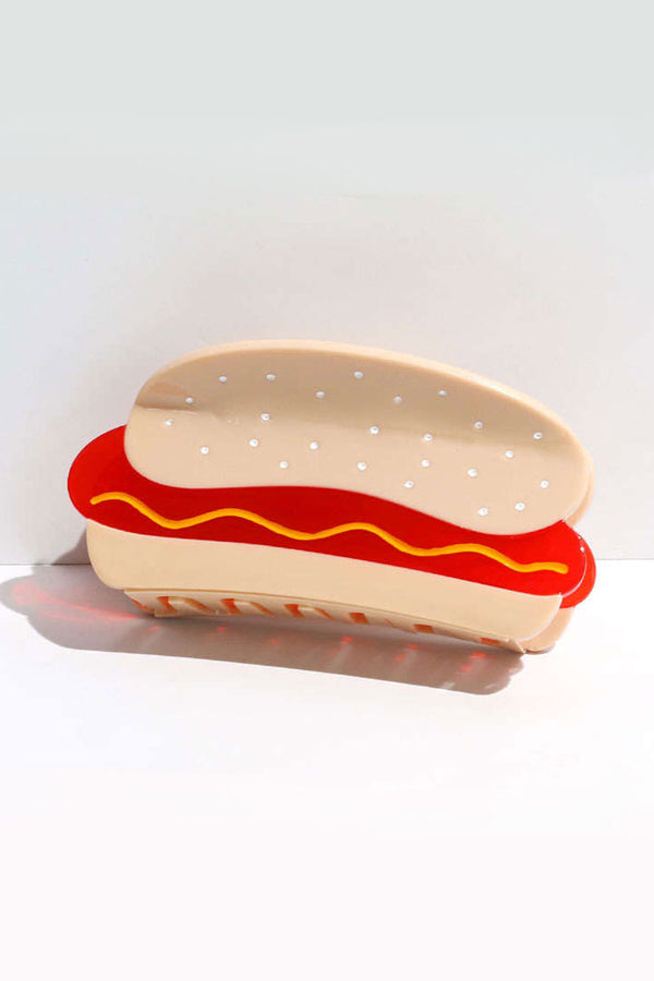 Hot dog with mustard shaped hair clip. White background.