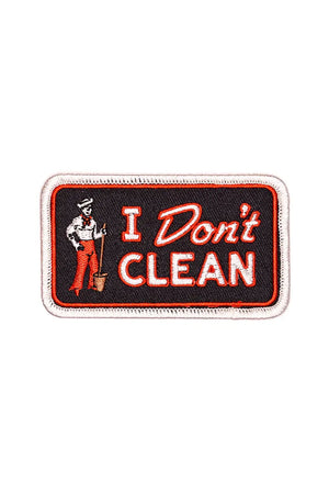 Black patch with white edge with a red border. The patch features a sailer with a mop and bucket and says I Dont Clean in white lettering that is outlined in red. White background.