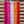 Load image into Gallery viewer, Photograph of the Lesbian Pride Flag hanging from a wooden fence. The flag consists of red, orange, white, pink, dark pink stripes.
