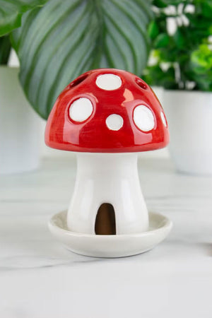 Red capped mushroom shaped incense burner.