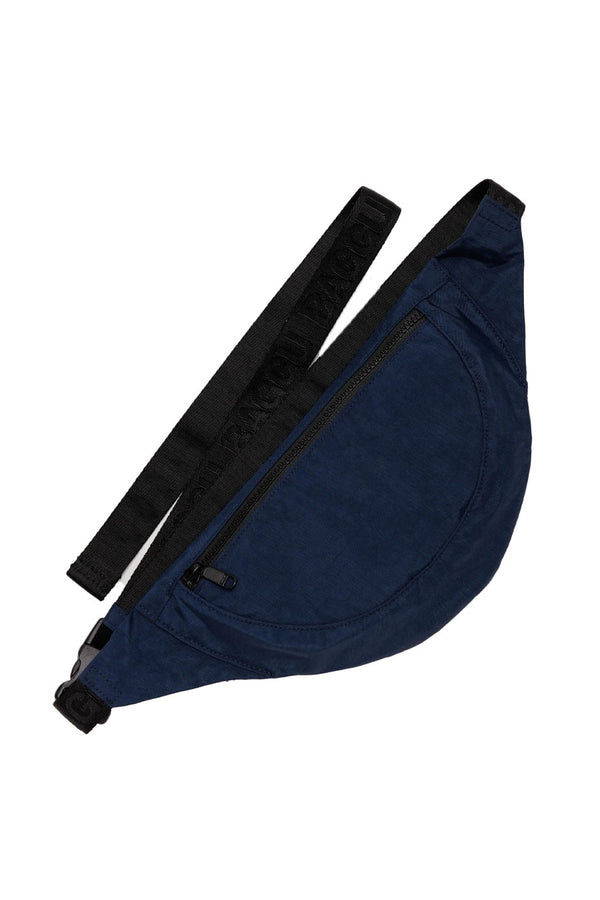 Crescent shaped fanny pack in Navy with black straps. White background.