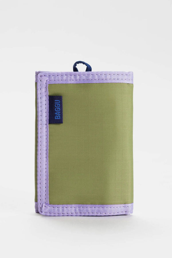 Pistachio green velcro wallet with lilac trim. The wallet features a navy loop for keychain attachment. White background.