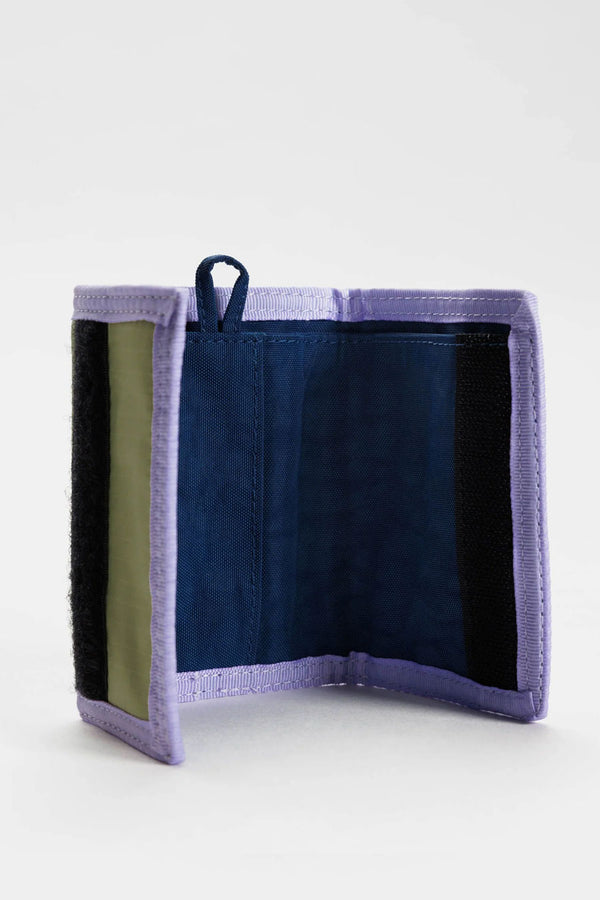 Pistachio green velcro wallet with lilac trim. The wallet features a navy loop for keychain attachment. Navy Blue interior. White background.