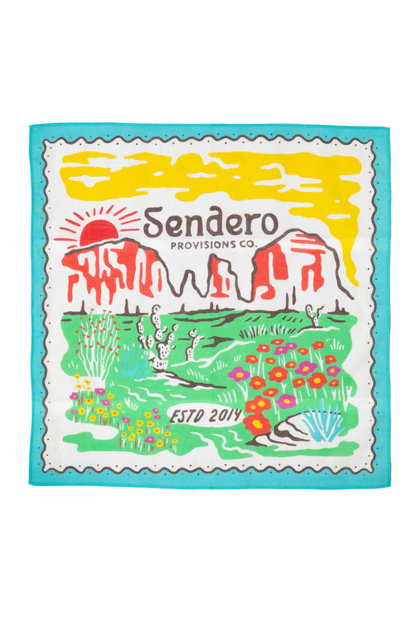 White bandana with a blue scallop border. The bandana features a yellow sky against a red and green desert landscape featuring colorful desert flowers and cacti. White background.