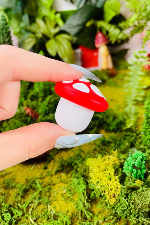 Small mushroom shaped silicone container.