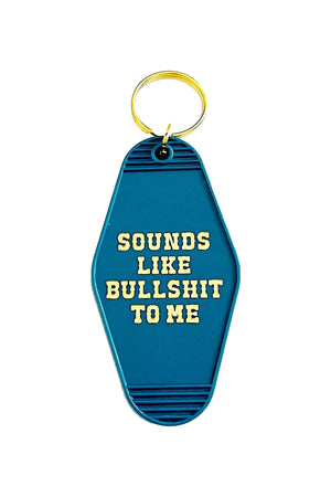 Blue vintage motel style keychain that says Sounds like Bullshit to me in yellow western style text. White background.