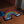Load image into Gallery viewer, Black rainbow shaped rug featuring rainbow color striped arches. On the left side under the stripes the rug says Then and on the right at the end of the stripes the rug says Now. This rug is at the doorstep of a house surrounded by sandals. 
