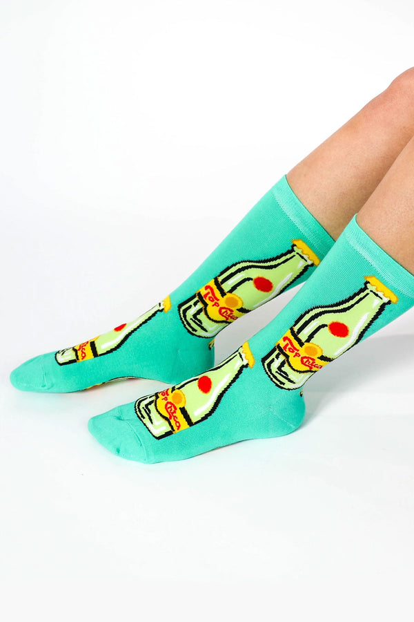 Green crew socks that feature a bottle of a parody of Topo Chico drinking water. The bottles instead say Top Chica.