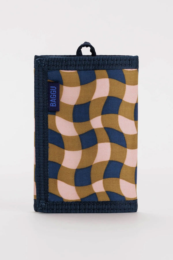 Navy, peach, and gold gingham patterned nylon wallet. The wallet has navy edges and features a key loop. White background.