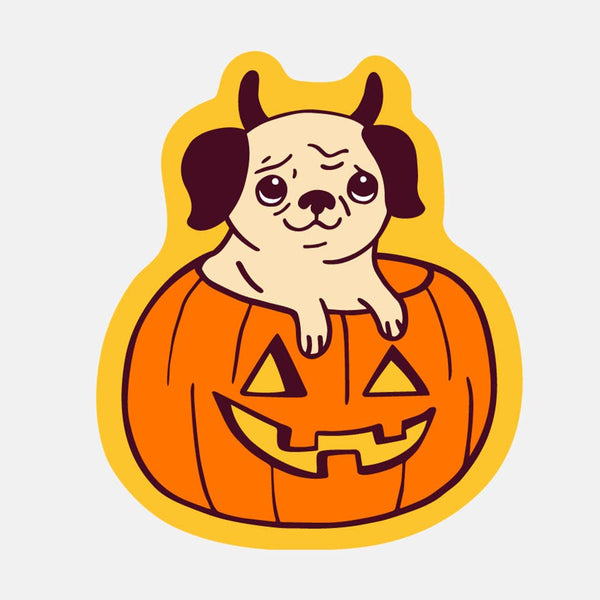 Yellow die cut sticker of a Pug with horns sticking out of a jack-o-lantern. White background.
