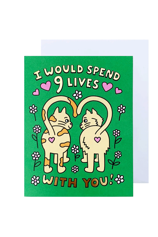 Green greeting card with white envelope on a white background. The card features two cats with their tails forming a heart with the caption I would Spend 9 Lives with You. 