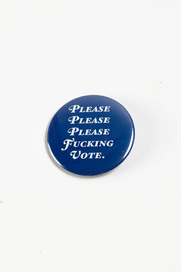 A royal blue pinback button on a white surface. The white text on the button reads "Please please please fucking vote."