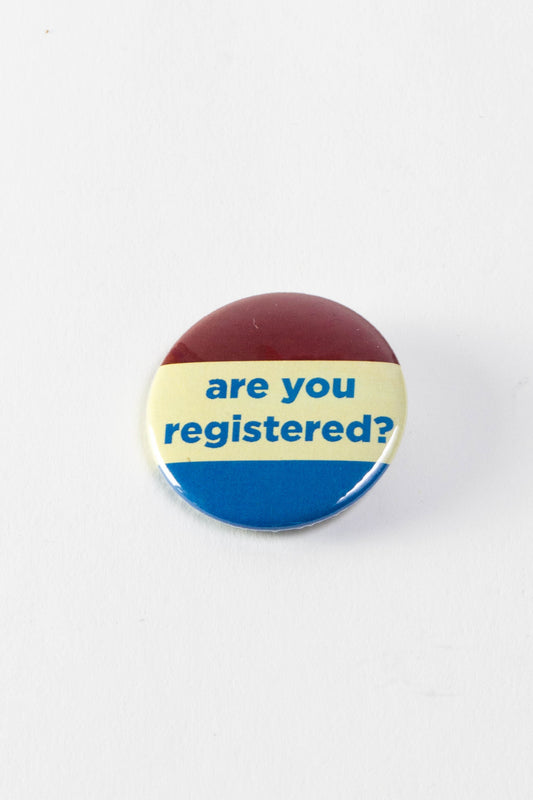 A red, white, and blue retro campaign-style button with the words "Are You Registered?" in the middle. 