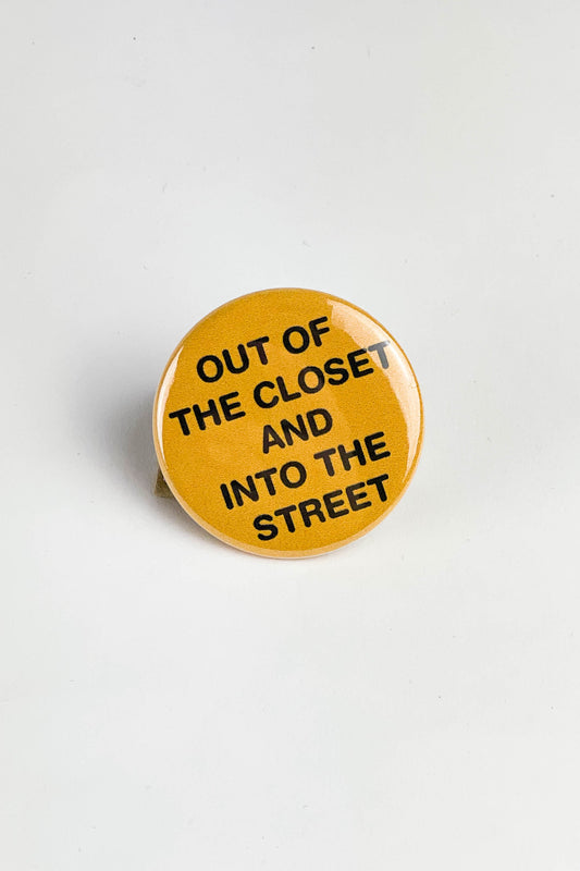 Yellow button on a white background. The button says Out of the Closet and Into the Street in black text.
