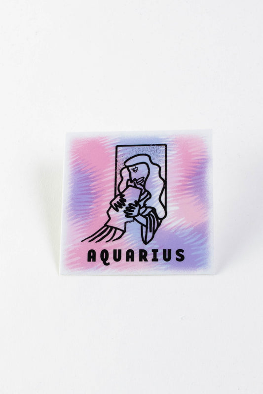 A purple and pink square sticker with a depiction of the astrological sign of Aquarius. Text reads "Aquarius" at the bottom. 