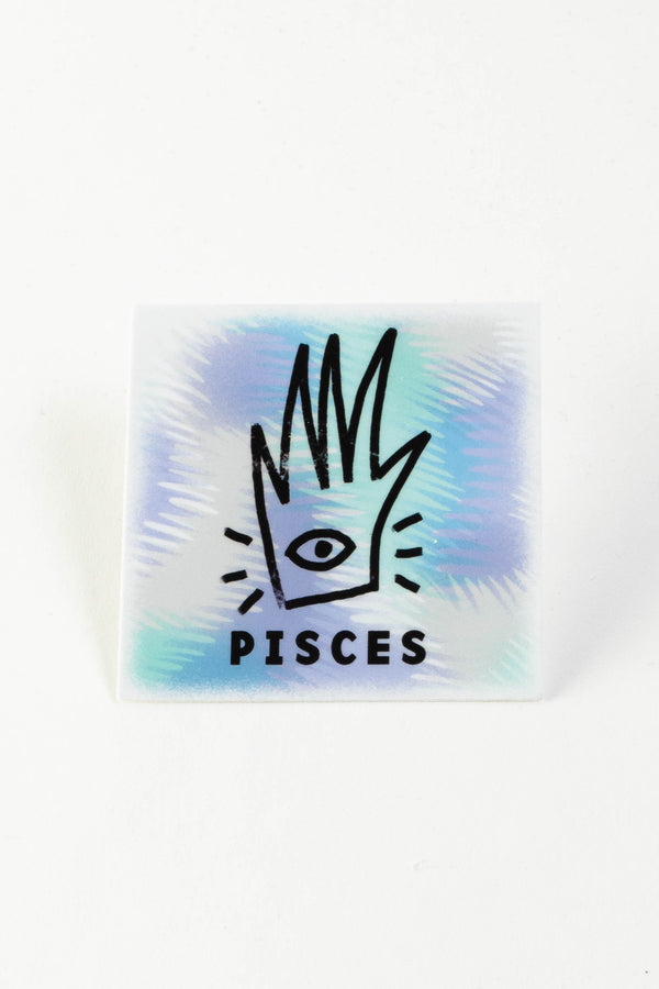 A square sticker with a white, purple, and teal background. The center has an abstract drawing of a hand with an eyeball. The text reads "Pisces."
