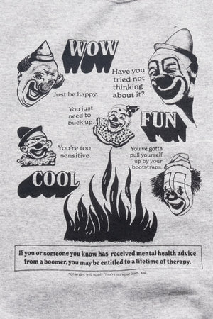 Close up design of Wow Fun Cool sweatshirt. Design is illustrations of clowns, flanked by the bold words "wow," "fun," and "cool." Flames are centered below the clown heads. The text reads "have you tried not thinking about it?" "Just be happy." "You're too sensitive." "You gotta pull yourself up by your bootstraps." "If you or someone you know has received mental health advice from a boomer, you may be entitled to a lifetime of therapy." Fine print reads "Charges will apply. You're on your own, kid."