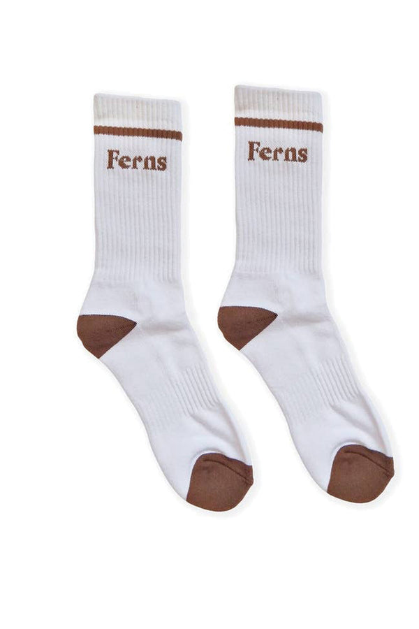 White pair of mid calf crew socks on a white background. The sicks have a brown tow and heel. The top of the socks have a brow stripe with the word Ferns spelled out in brown lettering. 