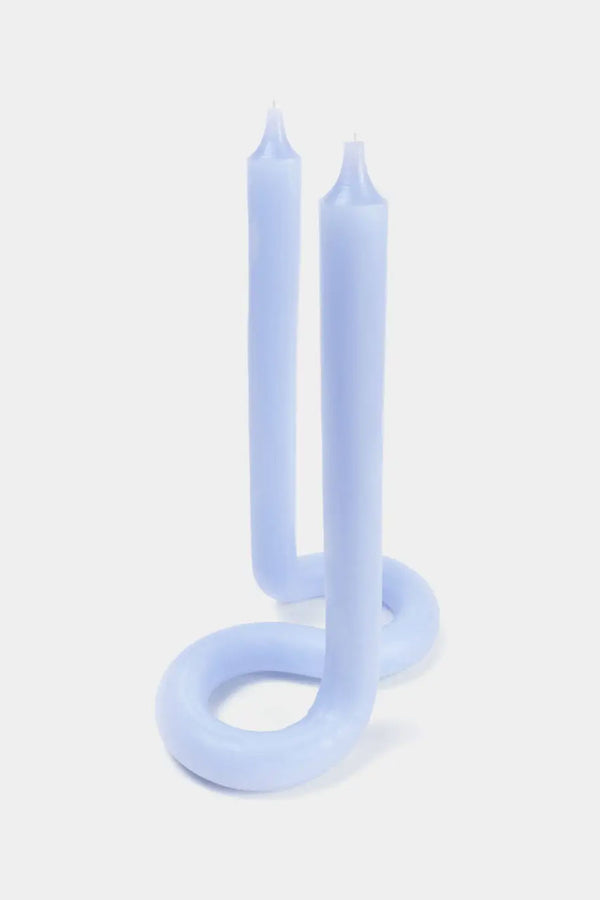 Lavender color twisted candle with wicks at both ends against a white background.