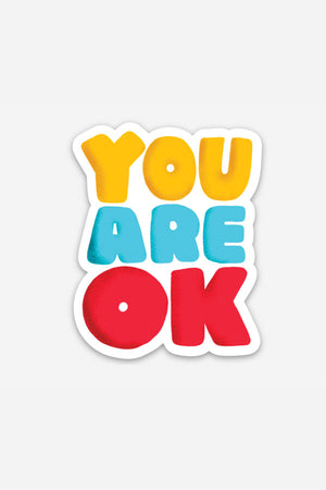 A die cut sticker that says "You Are OK" in yellow, teal, and red is sitting on a white background.