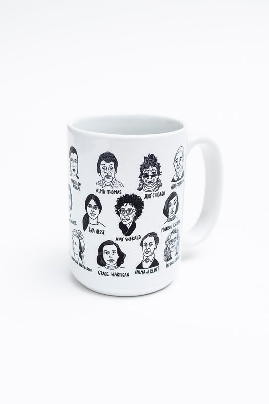 A white mug with illustrations of many historically significant female artists. 