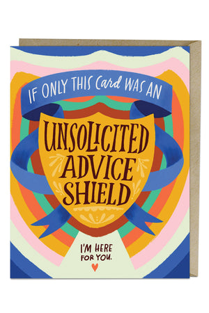 Colorful greeting card with kraft brown envelope on a white background. The card says inside a blue banner surrounding a shield "If only this card was an..." Under the banner is a Shield. The Shield says "Unsolicited Advice Shield" Surrounding the shield is a radiating rainbow of red, green, orange, yellow, pink, white, and blue. Under the Shield the card says "I'm here for you"with a red heart underneath the text.