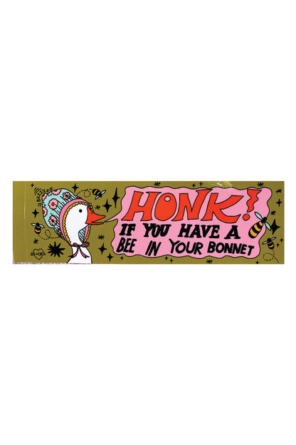 An olive green bumper sticker depicting a white goose wearing a bonnet. The pink text bubble reads "Honk if you have a bee in your bonnet."