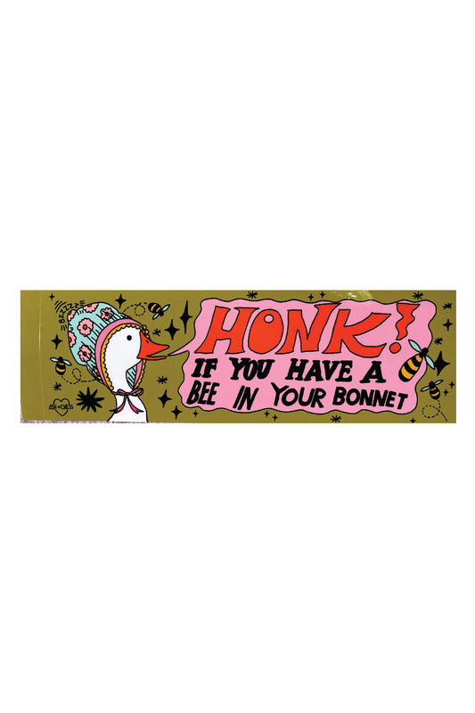 An olive green bumper sticker depicting a white goose wearing a bonnet. The pink text bubble reads "Honk if you have a bee in your bonnet."
