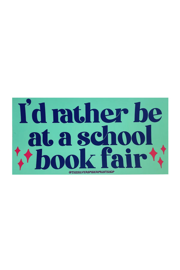 A teal rectangular bumper sticker with navy text that reads "I'd rather be at a school book fair." 