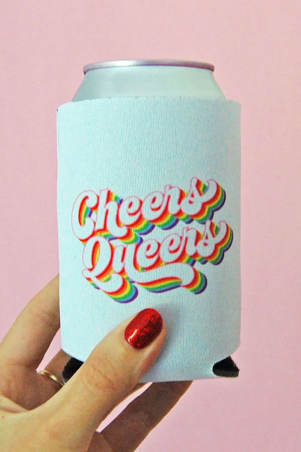 A person holding a can in a white koozie that says Cheers Queers with rainbow colors surrounding the text. Pink background.