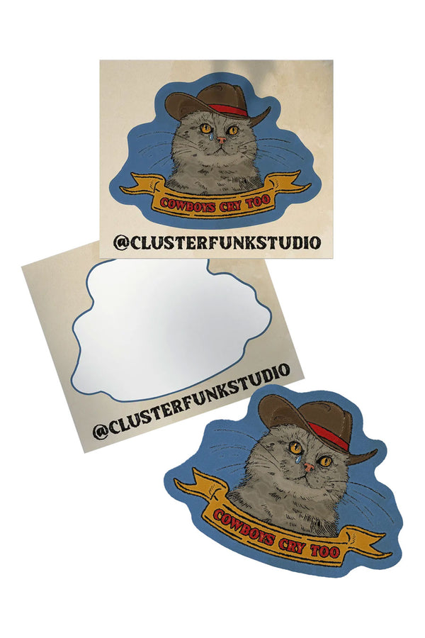Photo shows how the sticker of a cat wearing a cowboy hat is die-cut when removed from its backing.