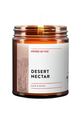 Amber Glass Candle Jar. There is a white label that says Desert Nectar. The scent is Aloe and Agave. The label also features a black and white photo of cacti in the desert. White background.