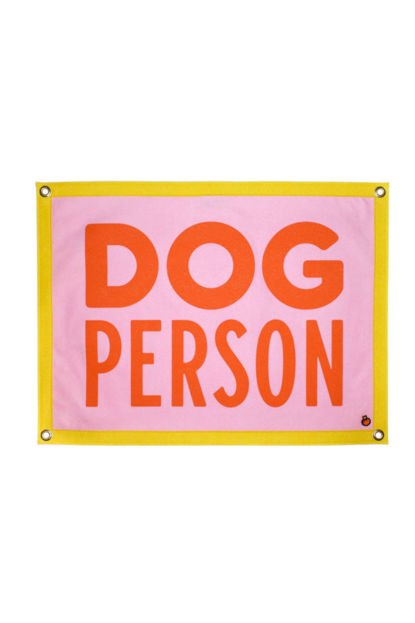 A yellow, pink, and orange felt flag with grommets at all four corners. The text reads "Dog Person" in orange letters on a pink background.