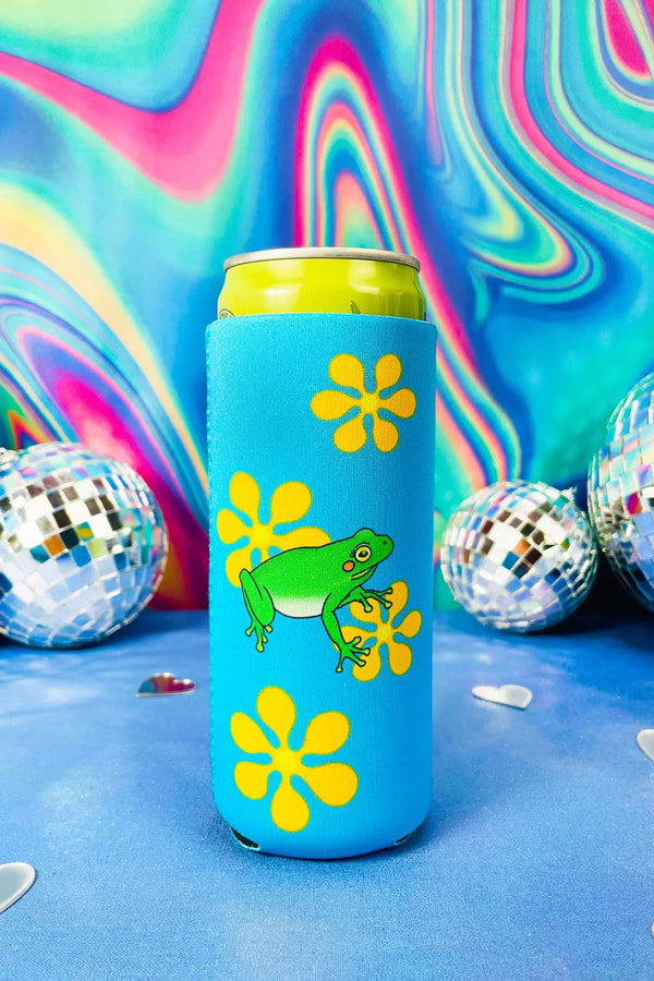 Bright blue tall koozie with yellow retro flowers printed all over it with a bright green frog in the middle. Rainbow swirls with disco balls in the background.