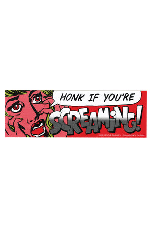A red rectangular bumper sticker with a cartoon woman with an anguished look on her face. The text reads "honk if you're screaming!"