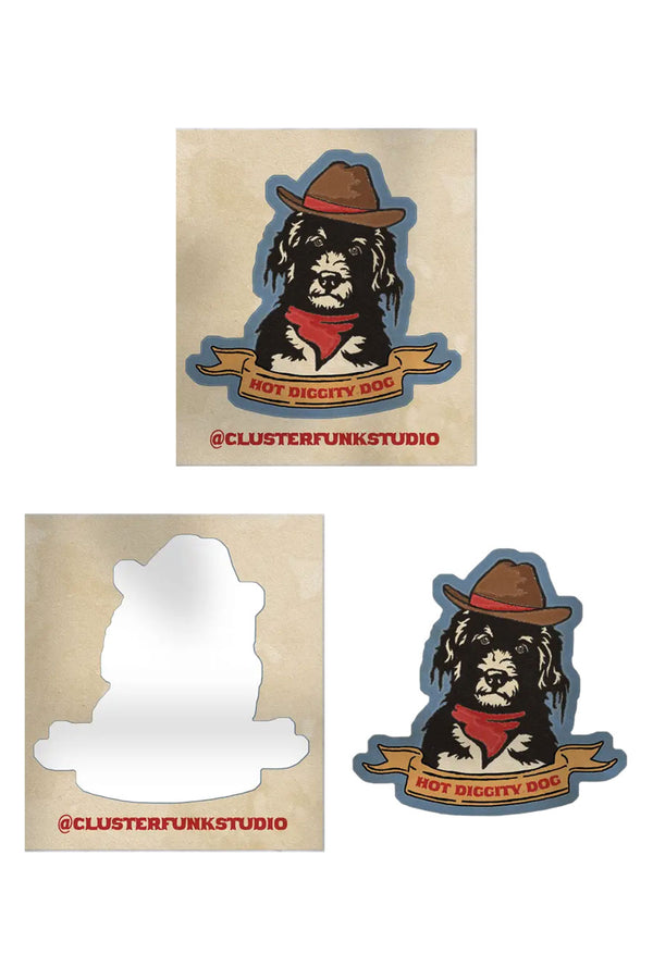Peel off sticker on white background. The blue sticker of a black and white shaggy dog wearing a cowboy hat and a banner reading Hot Diggity Dog underneath is on a beige square background.