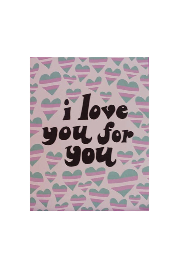 A pale pink greeting card with illustrated hearts in the striped colors of the transgender flag. The black text reads "i love you for you."