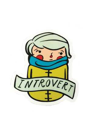 A die-cut sticker of an illustrated whimsical person in a mustard yellow overcoat and teal scarf with rosy cheeks. Across their chest is a banner that reads "Introvert."