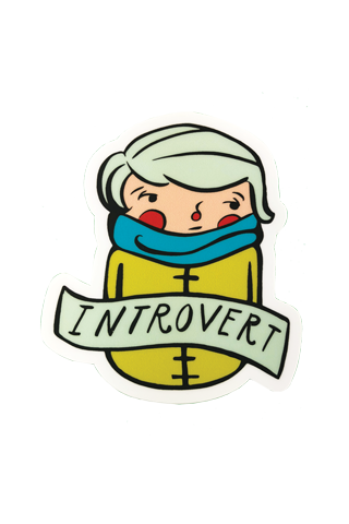 A die-cut sticker of an illustrated whimsical person in a mustard yellow overcoat and teal scarf with rosy cheeks. Across their chest is a banner that reads "Introvert."